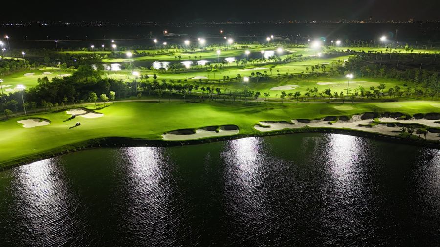 Floodlit fairway reflected in the lake
